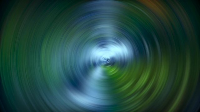 luces en movimiento en una imagen formando un molinillo de rotaci&oacute;n en redondo  con los colores suaves azules, verdes y blancos