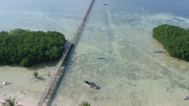 Drone shoot overview from the island to the sea with small boats