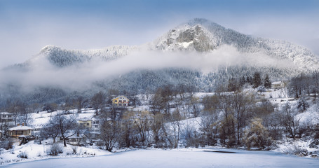 Winter landscape foggy clear sky trees houses hill mountain