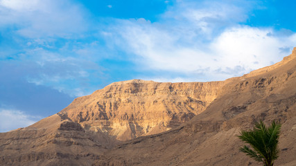 Panorama of stony slopes of the mountains against the sky.