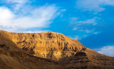 Fototapeta na wymiar Panorama of stony slopes of the mountains against the sky.