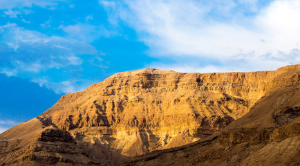 Panorama of stony slopes of the mountains against the sky.