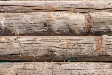 old wood gray round logs cracked  weathered pattern 