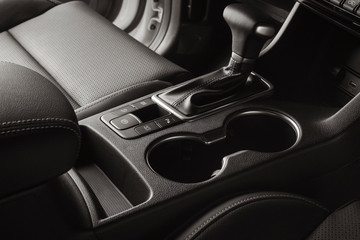 Vehicle interior with black leather seats and automatic gear lever