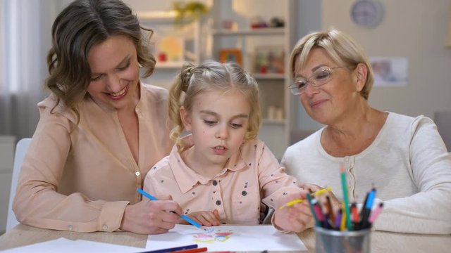 Elderly mother, daughter and grandchild drawing by color pencils, time together