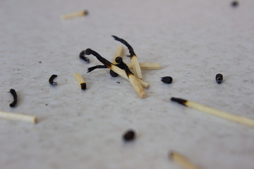 burnt matches on a white background