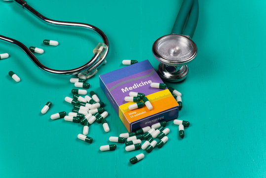 Health Care Medical And Sickness Concept. Pills And Medical Equipment Background With A Drug Box Fake Write 