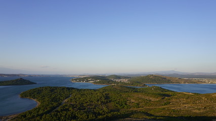 Fototapeta na wymiar Landscape of Devil's Table (Seytan Sofrasi) in Ayvalik, Aegean District in Turkey. Blue and green collaboration. Aerial view of famous touristic place as known Seytan Tepesi. High altitude. Acrophobia
