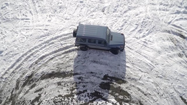 blue 4x4 G wagon from bird view revealing with stailized gimbal movement slow motion