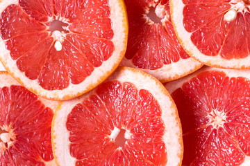 Flat lay of big slices of raw fresh grapefruit.