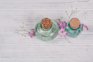 Abstract composition of fresh purple hyacinths flowers and bottles of organic cosmetic with essential oil