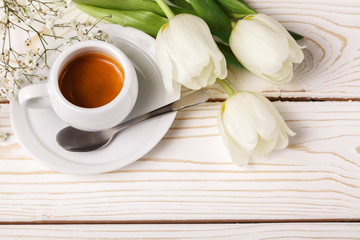 Fototapeta na wymiar Spring tulips and coffee on a white wooden background, top view. Mother's day background, women's day, morning Birthday