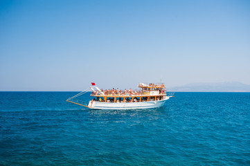 Obraz premium Yacht with tourists sailing on the sea, rest for all family, cruise on the islands
