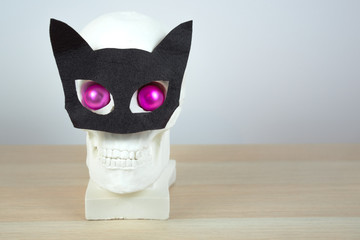 skull sculpture with black hat and a black  bow tie.  holiday background concept. Free space for design.