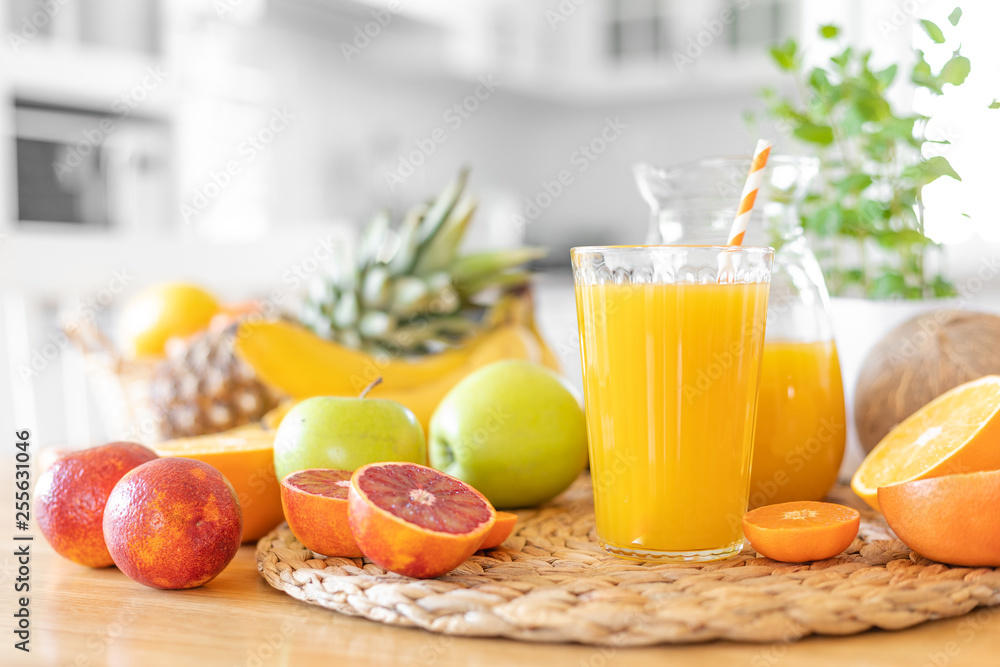 Canvas Prints multifruit juice and fresh fruit on table on kitchen background closeup