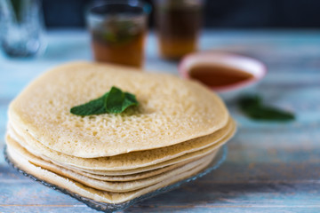 Moroccan pancakes Baghrir or crapes with 1000 holes served with honey, tea with nana , with...