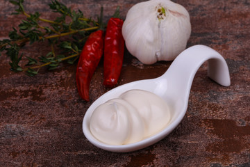 Mayonnaise sauce in the white bowl served thyme and garlic