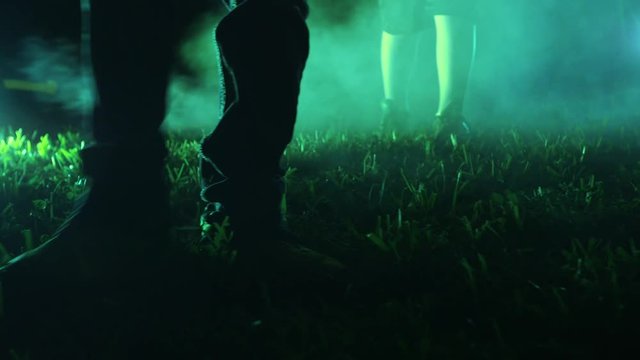 Three kids walk through foggy grass towards camera