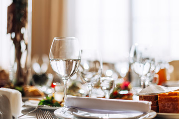 wineglass with alcohol drink on table for guests. Wedding table