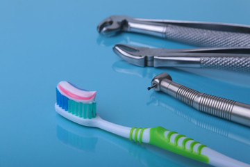 dental care toothbrush with dentist tools on mirror background