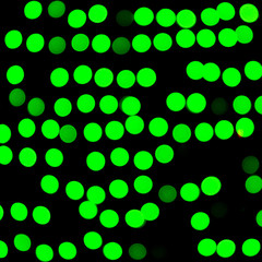 Unfocused abstract green bokeh on black background. defocused and blurred many round light