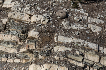 Shale mountains cement pits. The texture of the stone wall. Large stone cracks, the separation of...