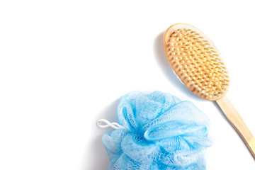 Wooden body brush and sponge for massage and scrub on white background with copy space - skincare in shower and bath