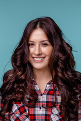 Closeup portrait of pretty yong woman with bright makeup in a glasses isolated over the blue background