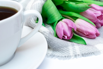 Bouquet of spring flowers, pink tulips on checkered plaid background with a cup of coffee - holiday business card for 8 march, Valentine day or mother's day