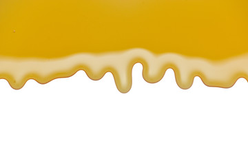 Pouring honey over white background