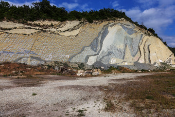 Shale mountains cement pits. The texture of the stone wall. Large stone cracks, the separation of the stone ridge. Background of stone wall texture. Stone for construction cement production