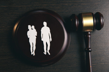 Family figure and gavel on table. Family law concept