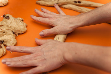 woman prepares and knits the dough for Christmas cake.