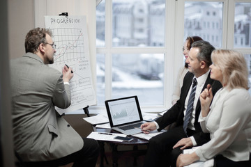 confident businessman showing business partners financial schedule