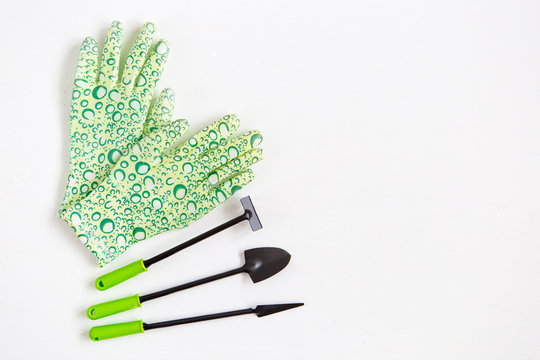 Rubber Gloves And Garden Tools On White Background