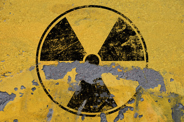 Black radioactive sign over yellow background