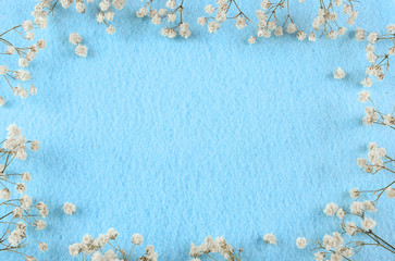 Blue felt background and babies breath border with copy space. Great for wedding, anniversary,...