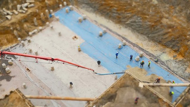 Workers pouring concrete at a construction site view from above time lapse