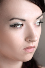 closeup. a young woman with daily makeup looks up