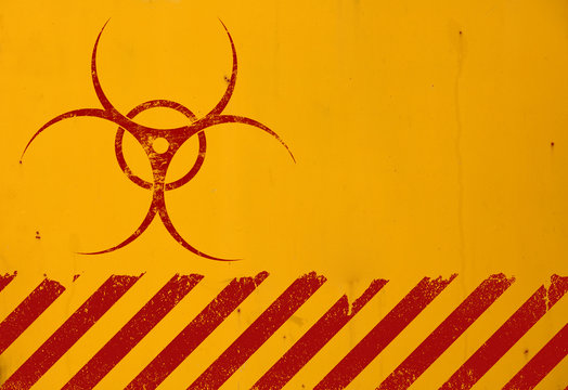 Red biohazard sign over yellow background