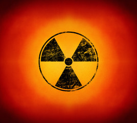 Black radioactive sign over yellow background