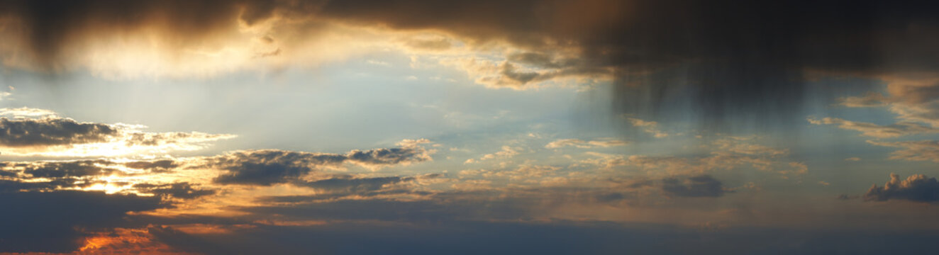 Sunset rainy cloudy sky panorama