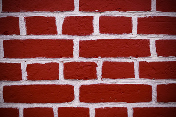 Obraz premium wall of red bricks with white paint texture, background. vignette, exterior
