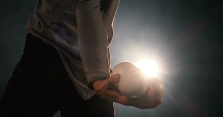 ball in hand of artist in the backlight of the stage.