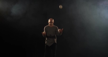 Juggler on the stage makes tricks with 7 ball - 4k slow motion.