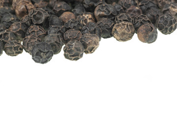Close up heap of black pepper, peppercorns isolated on white background, dried spice pepper corn concept