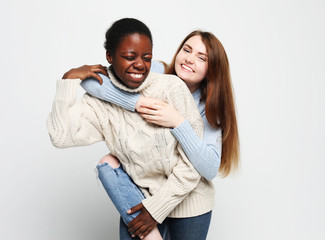 Multiethnic friendship concept. Cheerful European and African women.