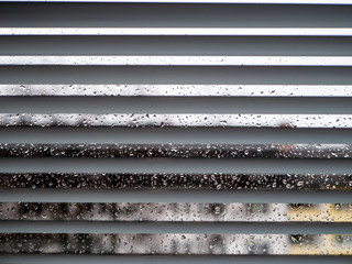 Rainy weather: Wet window with raindrops and grey sky