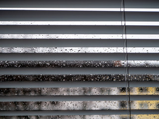 Rainy weather: Wet window with raindrops and grey sky