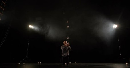 Amazng circus juggler makes tricks on the stage.